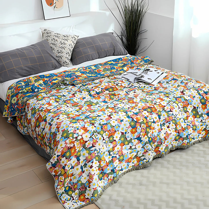 Wendbarer Sofaüberwurf aus Baumwolle mit Gänseblümchen und Quasten