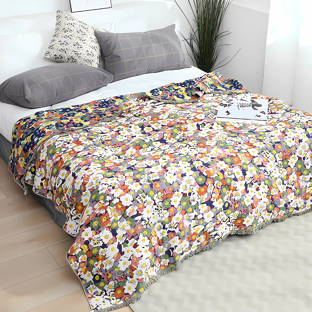 Wendbarer Sofaüberwurf aus Baumwolle mit Gänseblümchen und Quasten