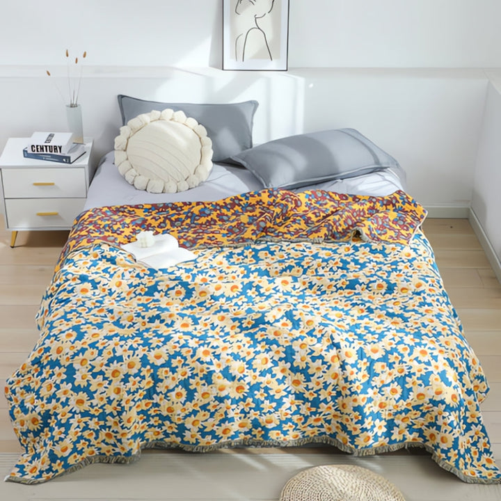 Wendbarer Sofaüberwurf aus Baumwolle mit Gänseblümchen und Quasten