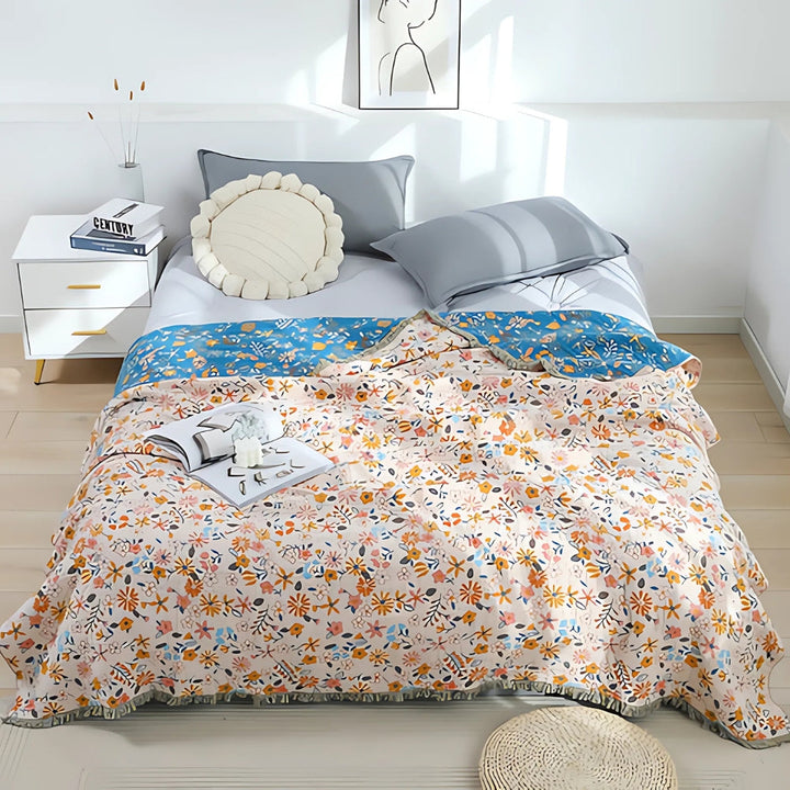 Wendbarer Sofaüberwurf aus Baumwolle mit Gänseblümchen und Quasten