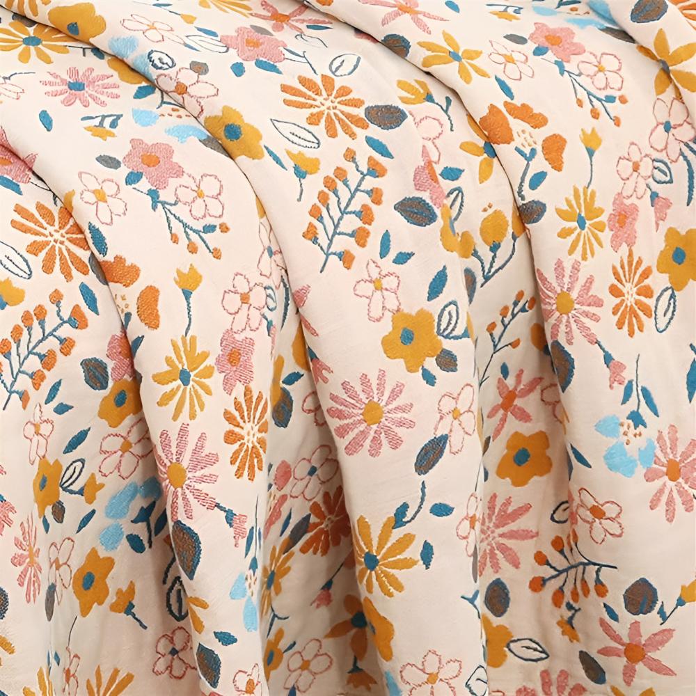 Wendbarer Sofaüberwurf aus Baumwolle mit Gänseblümchen und Quasten