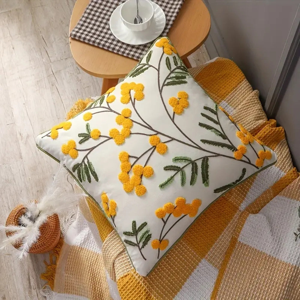 Kissenhülle mit gelben Blumenstickereien auf festem Stoff
